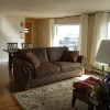 The living room and dining room with a picture window of the river. The brand new sofa bed forms a Queen bed.